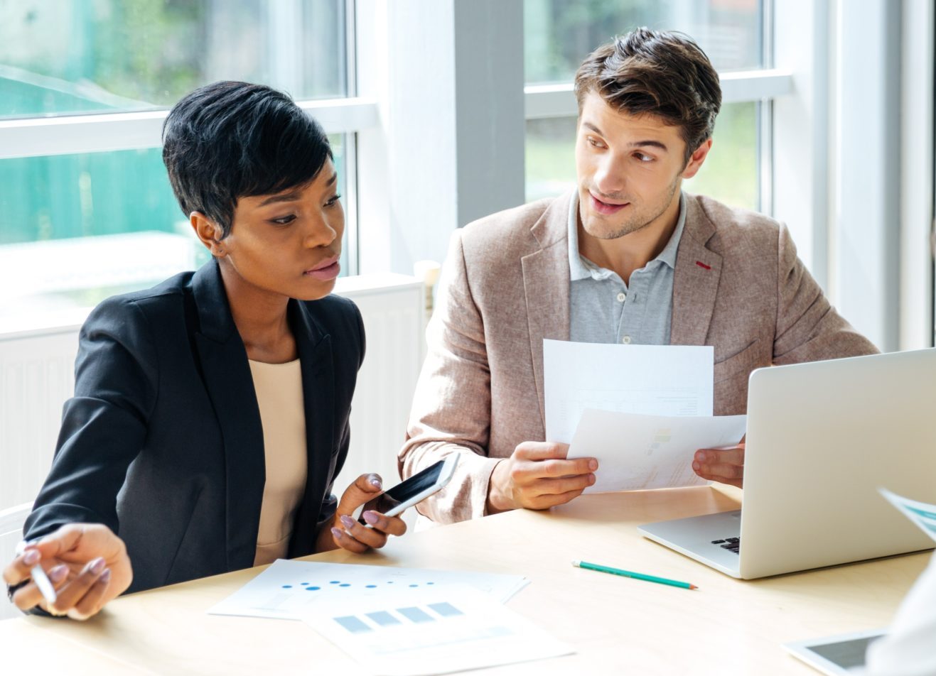 graphicstock-multiethnic-group-of-young-businesspeople-working-together-on-business-me-SBI-302738018-1-1-2048x954-1-e1711373564797